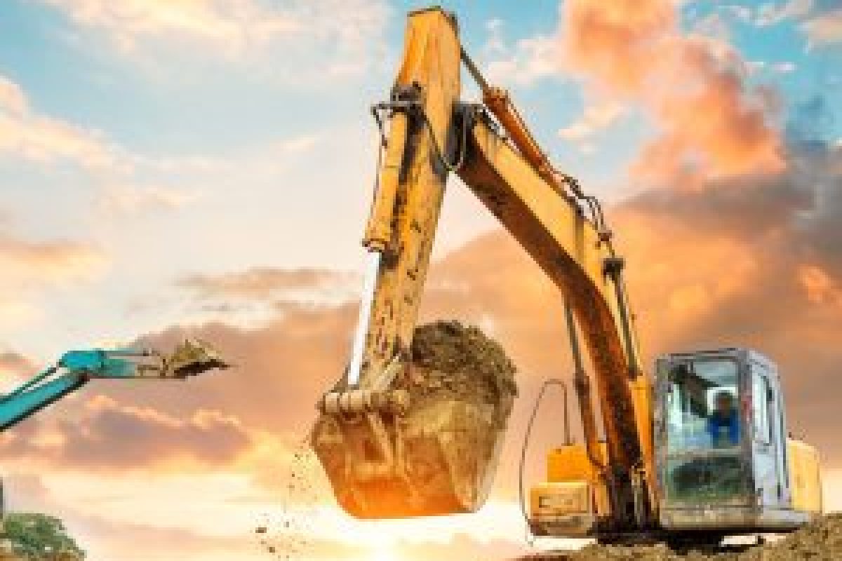 excavator in construction site on sunset sky background
